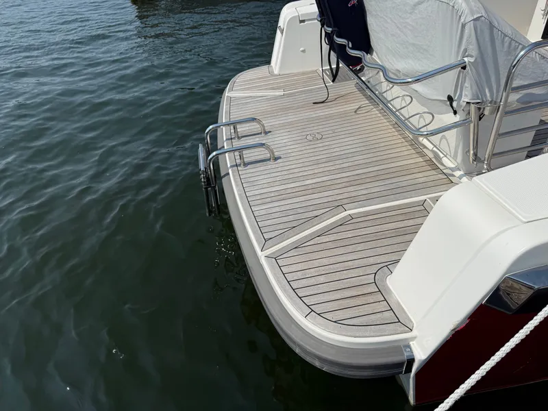 Slide: The Image of The image shows the stern of a 2024 Nimbus Commuter 11 with a swim platform. - 22