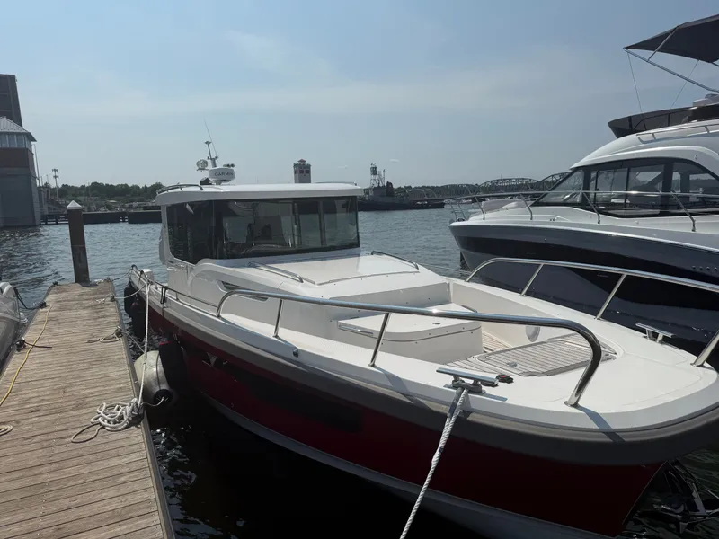 Slide: The Image of 2024 Nimbus Commuter 11 at dock, featuring a sleek design and spacious deck. - 4