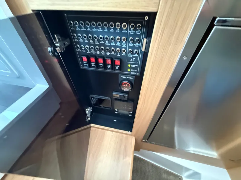 Slide: The Image of Electrical panel inside a 2024 Nimbus Commuter 11 boat. - 16