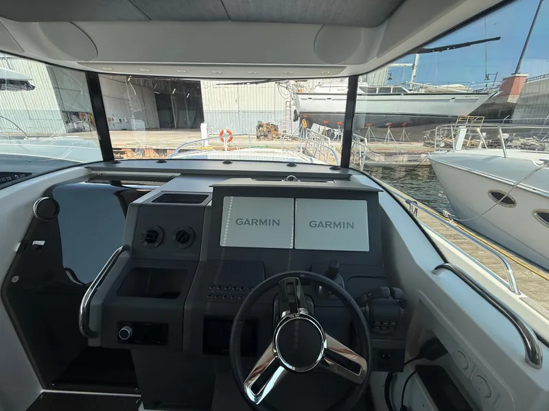 Slide: The Image of The image shows the cockpit of a 2024 Nimbus Commuter 11 with two Garmin screens. - 8