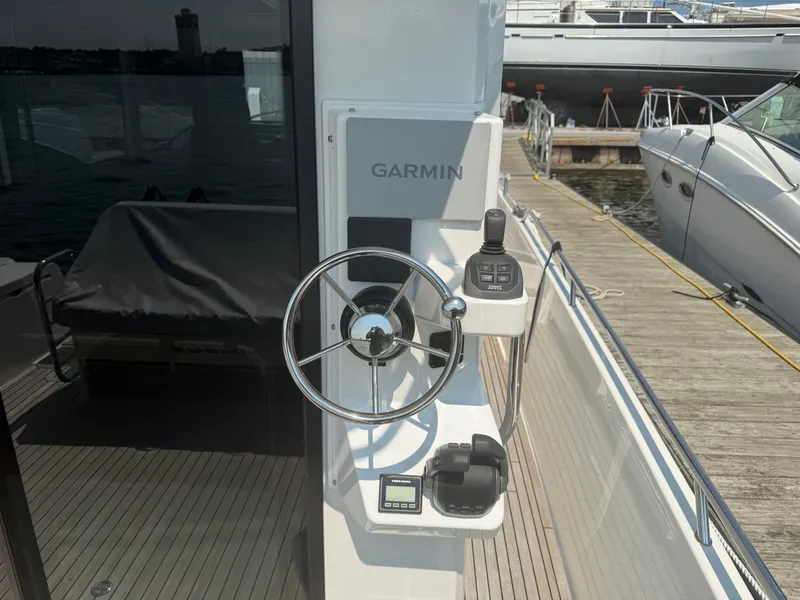 Slide: The Image of Helm of the Nimbus Commuter 11 with Garmin equipment, docked at a pier. - 5
