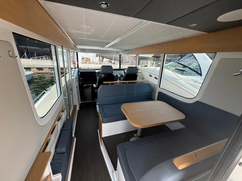 Slide: The Image of Interior of the 2024 Nimbus Commuter 11 with seating area and table. - 6