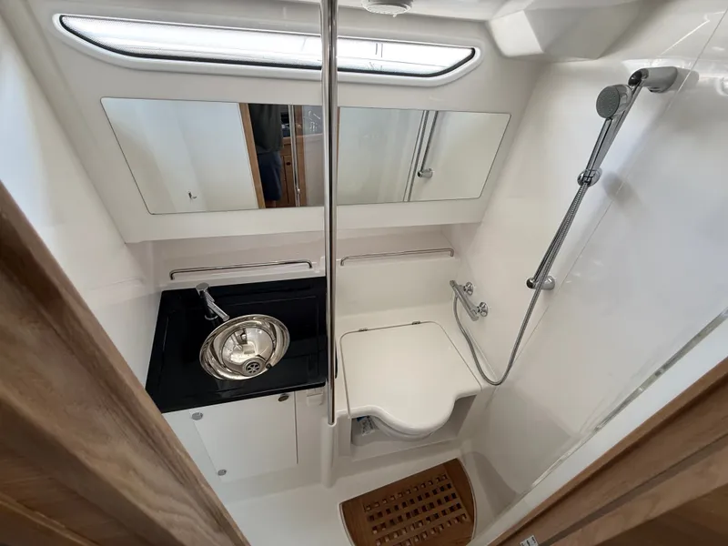 Slide: The Image of The image shows the bathroom of a 2024 Nimbus Commuter 11 with a shower and sink. - 14