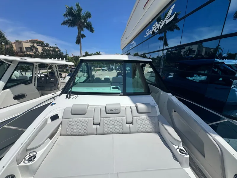 Slide: The Image of The image shows the cockpit of a 2027 Sea Ray Sundancer 320 Outboard with luxurious seating. - 17