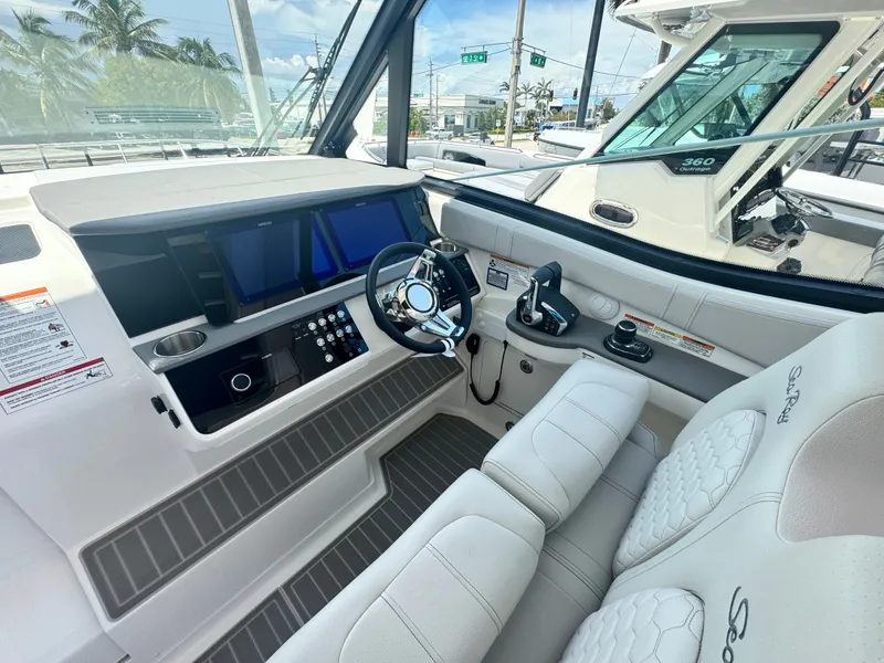 Slide: The Image of The cockpit of the 2027 Sea Ray Sundancer 320 Outboard features modern controls and instruments. - 9