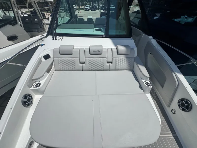 Slide: The Image of The image shows the cockpit of a Sea Ray Sundancer 320 Outboard with gray upholstery and speakers. - 16