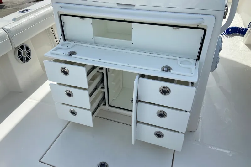 Slide: The Image of 2022 Regulator 34 boat storage compartment with open drawers and cabinets. - 31