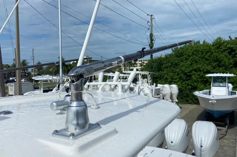 Slide: The Image of 2022 Regulator 34 boat with TACO marine outrigger, docked with other boats. - 33