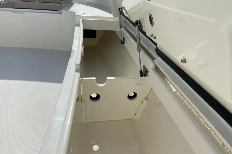 Slide: The Image of 2022 Regulator 34 boat storage compartment with hydraulic lift and white interior. - 50