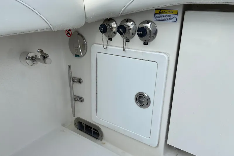 Slide: The Image of 2022 Regulator 34 boat deck with storage compartment and control knobs. - 20