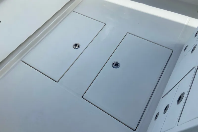 Slide: The Image of 2022 Regulator 34 boat deck with storage compartments and sleek design. - 26