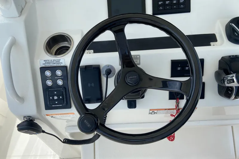 Slide: The Image of Steering wheel and controls of 2022 Regulator 34 boat cockpit. - 41