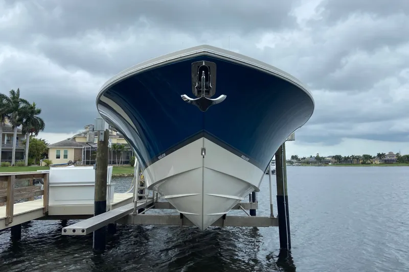 Slide: The Image of 2022 Regulator 34 boat docked, showcasing sleek design against a cloudy sky backdrop. - 10