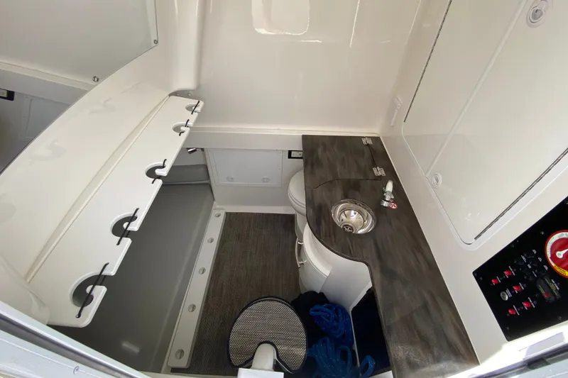 Slide: The Image of 2022 Regulator 34 boat interior with sink, storage, and control panel. - 60