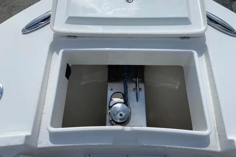 Slide: The Image of Open anchor locker on 2022 Regulator 34 boat, showcasing chain and winch mechanism. - 54