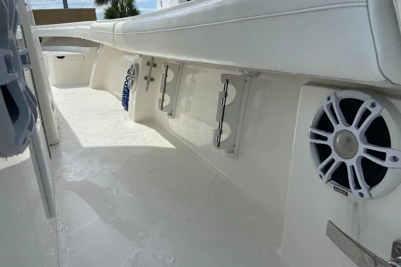 Slide: The Image of 2022 Regulator 34 boat interior with white seating and built-in speakers. - 46