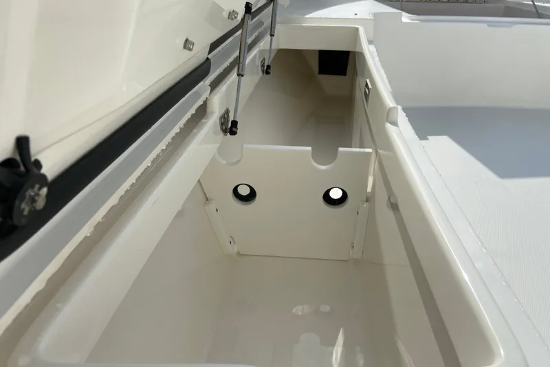 Slide: The Image of 2022 Regulator 34 boat storage compartment, open and empty, showcasing interior design. - 51