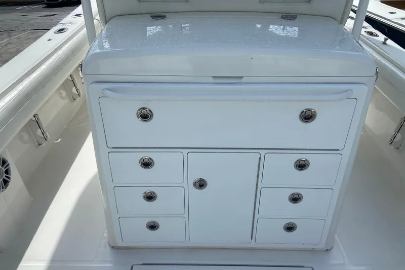 Slide: The Image of 2022 Regulator 34 boat storage compartment with multiple drawers and sleek design. - 29