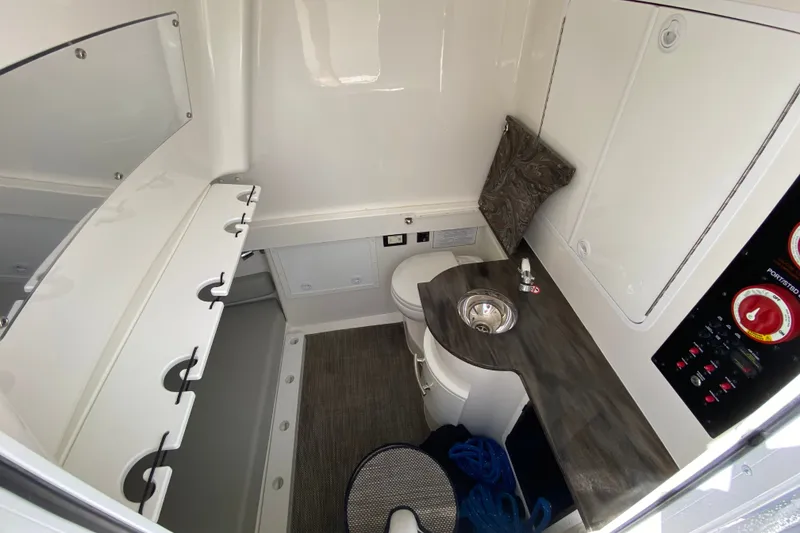Slide: The Image of 2022 Regulator 34 boat interior with sink, toilet, and control panel. - 61
