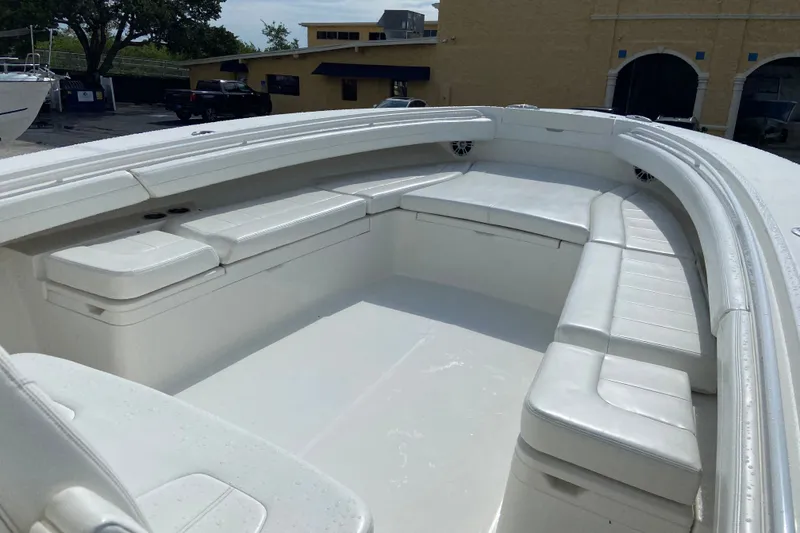 Slide: The Image of 2022 Regulator 34 boat interior with spacious white seating and sleek design. - 55