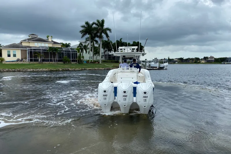 Slide: The Image of 2022 Regulator 34 boat with triple 300 V6 engines on a scenic waterway. - 5