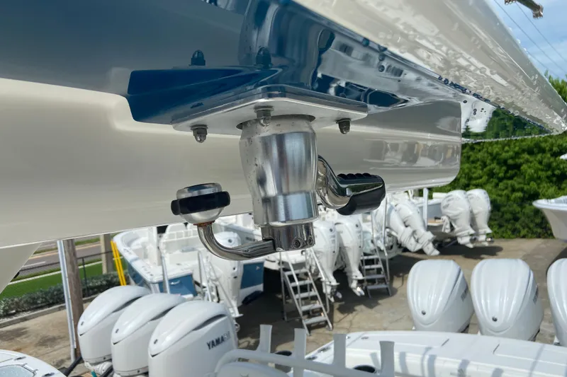 Slide: The Image of Close-up of a 2022 Regulator 34 boat's fishing rod holder and outboard motors. - 35