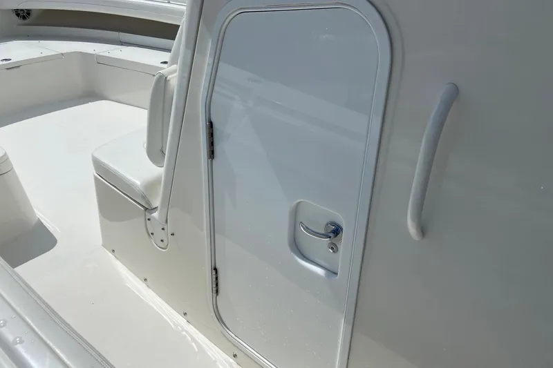 Slide: The Image of 2022 Regulator 34 boat interior with seating and cabin door. - 59