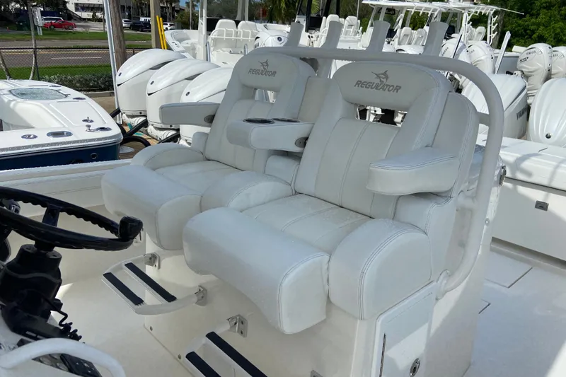 Slide: The Image of 2022 Regulator 34 boat with luxurious white seating and steering wheel. - 39