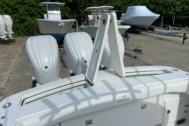 Slide: The Image of 2022 Regulator 34 boat with dual outboard engines in a marina setting. - 17