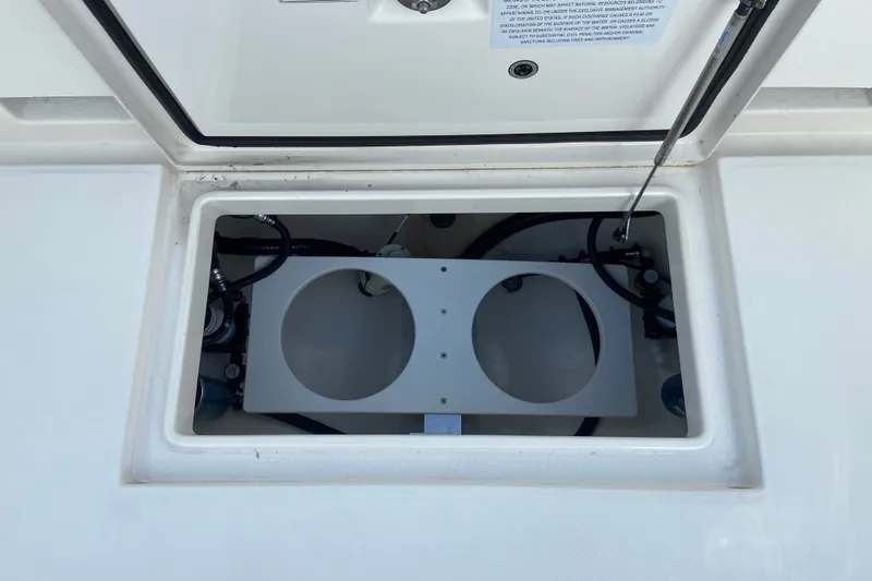 Slide: The Image of 2022 Regulator 34 boat compartment with open hatch and visible wiring. - 27