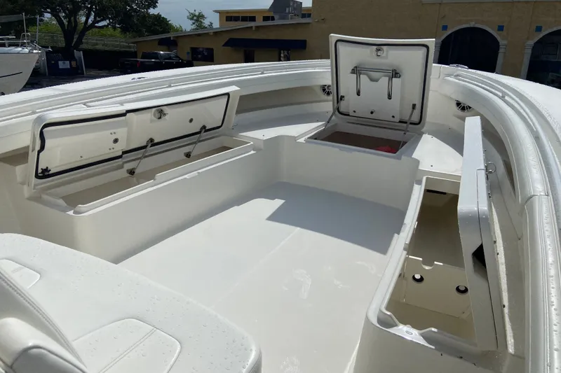 Slide: The Image of 2022 Regulator 34 boat with open storage compartments on deck. - 49