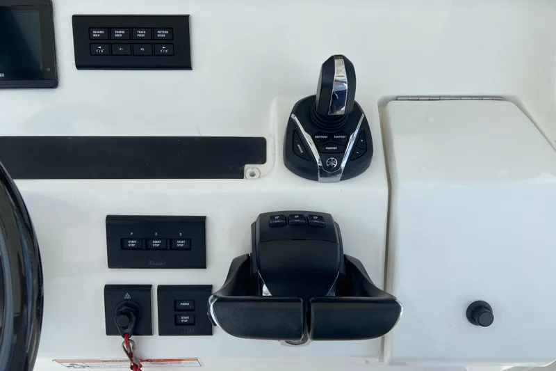 Slide: The Image of Control panel of a 2022 Regulator 34 boat with joystick and switches. - 42