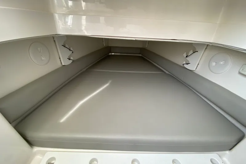 Slide: The Image of 2022 Regulator 34 boat interior cabin with cushioned seating and storage compartments. - 62