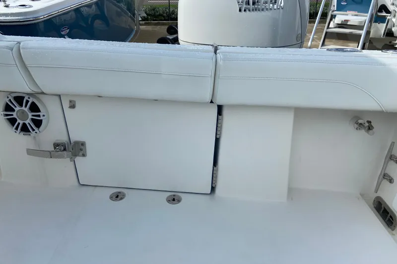 Slide: The Image of 2022 Regulator 34 boat interior with white seating and storage compartment. - 24