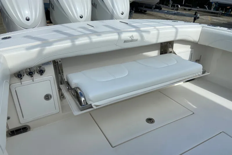 Slide: The Image of 2022 Regulator 34 boat with foldable seating and Yamaha engines in the background. - 16
