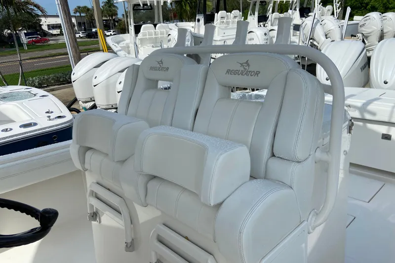 Slide: The Image of 2022 Regulator 34 boat with white leather seating and multiple outboard engines. - 38