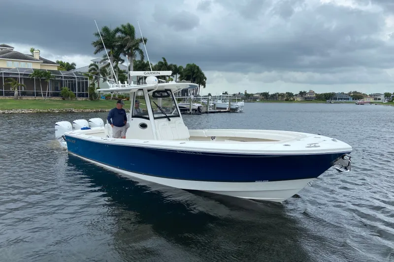 The Image of 2022 Regulator 34 boat on water, featuring a sleek blue hull and modern design. - 0