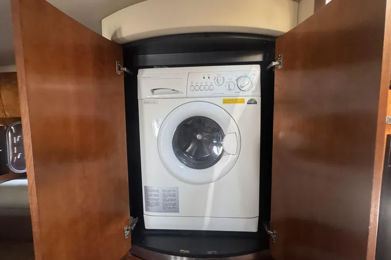 Slide: The Image of Washing machine inside 2006 Cruisers Yachts 520 Express wooden cabinet. - 31