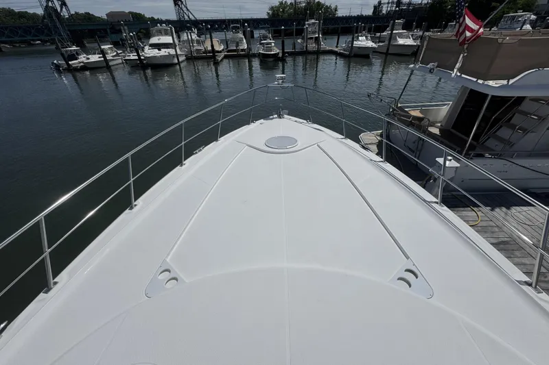 Slide: The Image of Bow view of 2006 Cruisers Yachts 520 Express docked at marina with boats. - 37