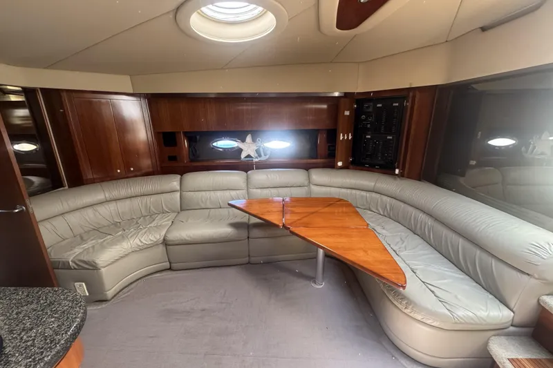 Slide: The Image of Luxurious 2006 Cruisers Yachts 520 Express interior with leather seating and wooden table. - 28