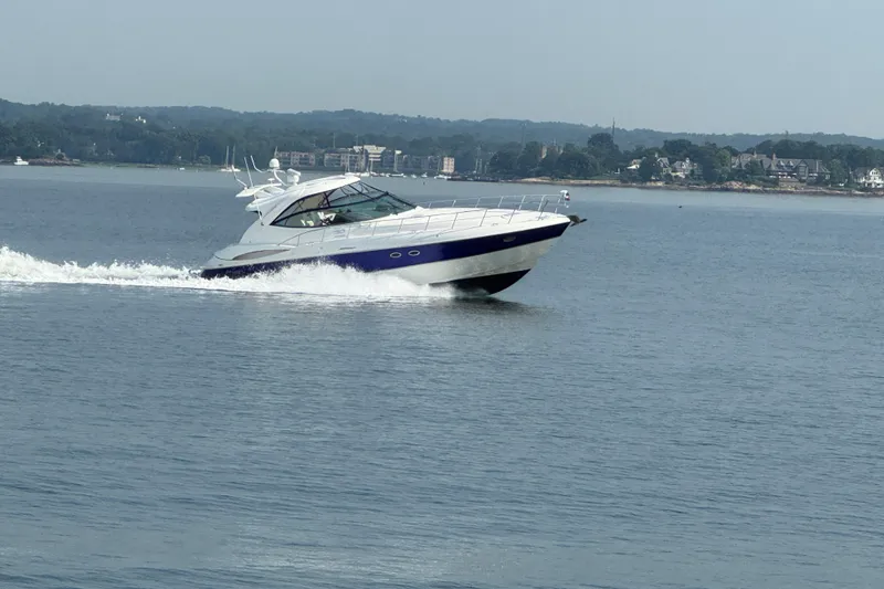 Slide: The Image of 2006 Cruisers Yachts 520 Express cruising on a calm lake with scenic shoreline. - 7