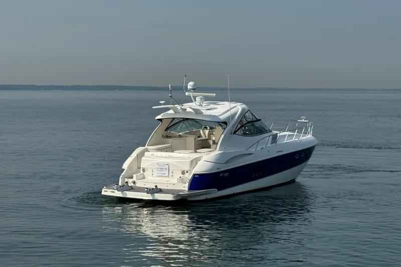 Slide: The Image of 2006 Cruisers Yachts 520 Express on calm water, showcasing sleek design and luxury features. - 2