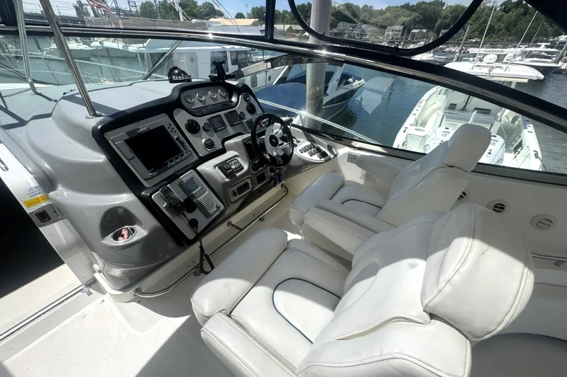 Slide: The Image of Helm of 2006 Cruisers Yachts 520 Express with white seating and control panel. - 21
