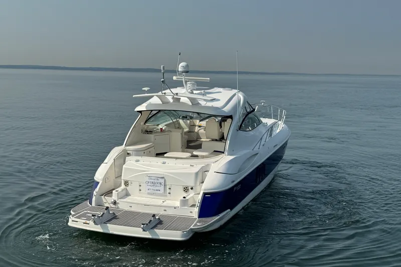 Slide: The Image of 2006 Cruisers Yachts 520 Express on calm water, rear view showcasing sleek design. - 6