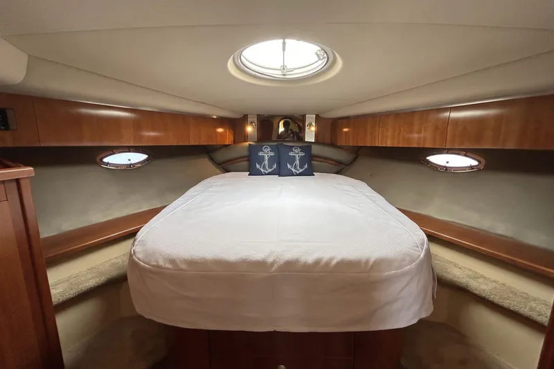 Slide: The Image of Luxurious cabin interior of 2006 Cruisers Yachts 520 Express with elegant wood finish. - 34