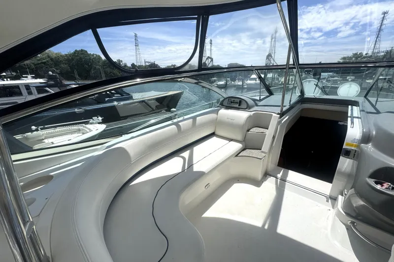 Slide: The Image of 2006 Cruisers Yachts 520 Express cockpit with seating, docked at marina under clear sky. - 20