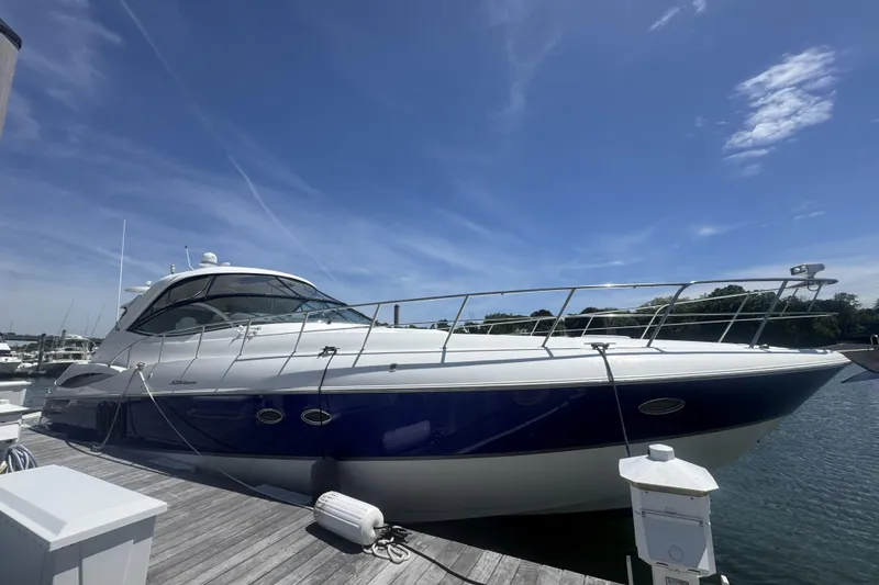 Slide: The Image of 2006 Cruisers Yachts 520 Express docked under a clear blue sky. - 9