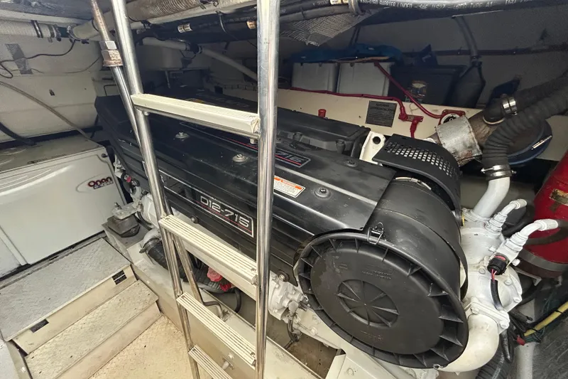 Slide: The Image of Engine room of 2006 Cruisers Yachts 520 Express with visible machinery and ladder. - 41