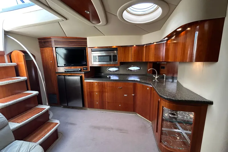 Slide: The Image of Luxurious 2006 Cruisers Yachts 520 Express interior with modern kitchen and entertainment area. - 24