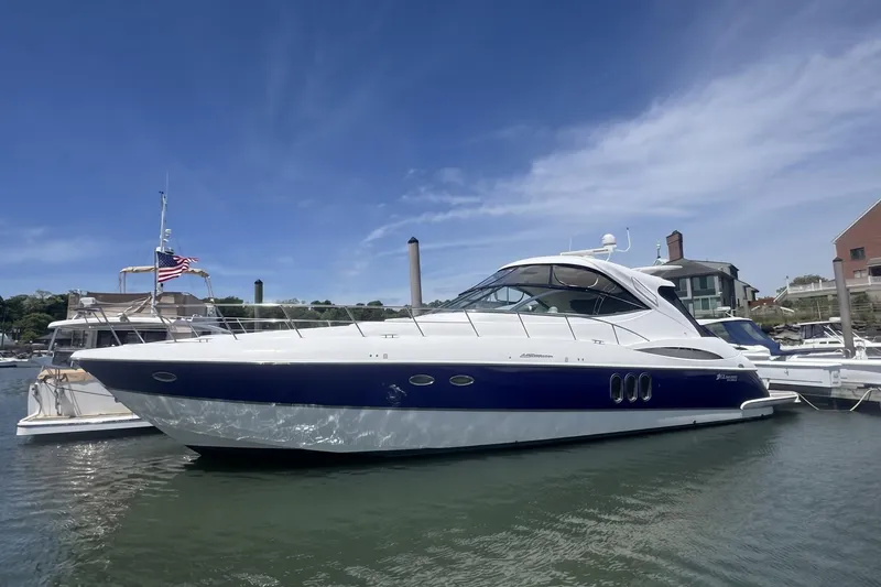 Slide: The Image of 2006 Cruisers Yachts 520 Express docked in a marina under a clear blue sky. - 8